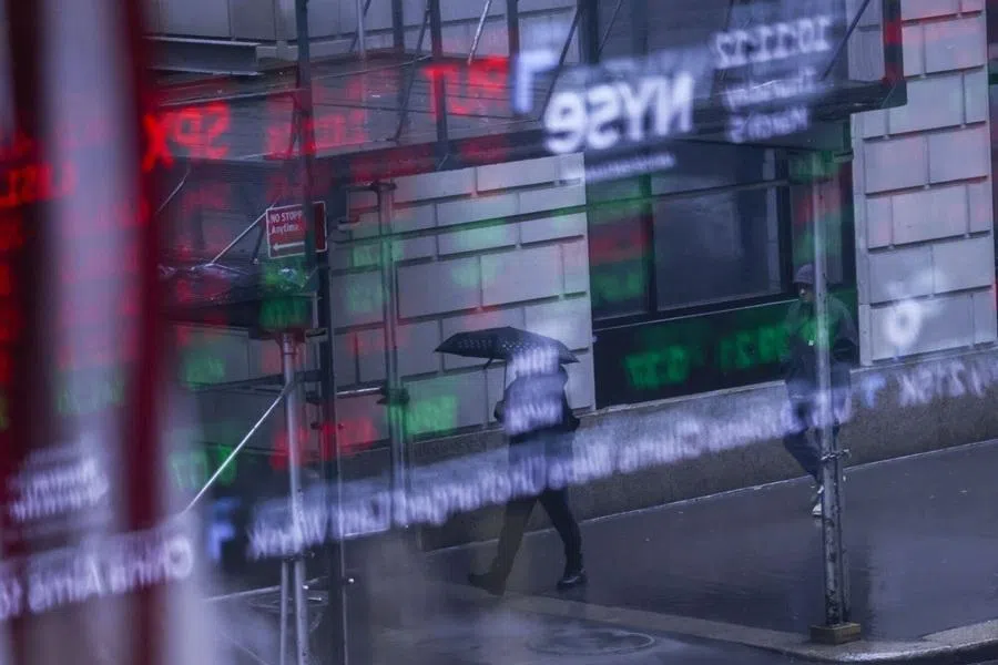 A pedestrian holding an umbrella walks outside the New York Stock Exchange (NYSE) in New York, US, on 5 March 2026.