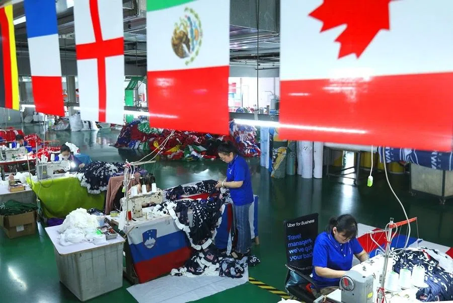 Workers make flags and banners ahead of the World Cup football tournament, at a factory in Qingdao, Shandong province, China, on 28 May 2026.