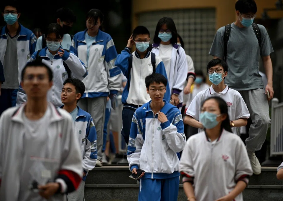 Students leave school after finishing the first day of the National College Entrance Examination (NCEE), known as "Gaokao", in Beijing on 7 July 2021. (Noel Celis/AFP)