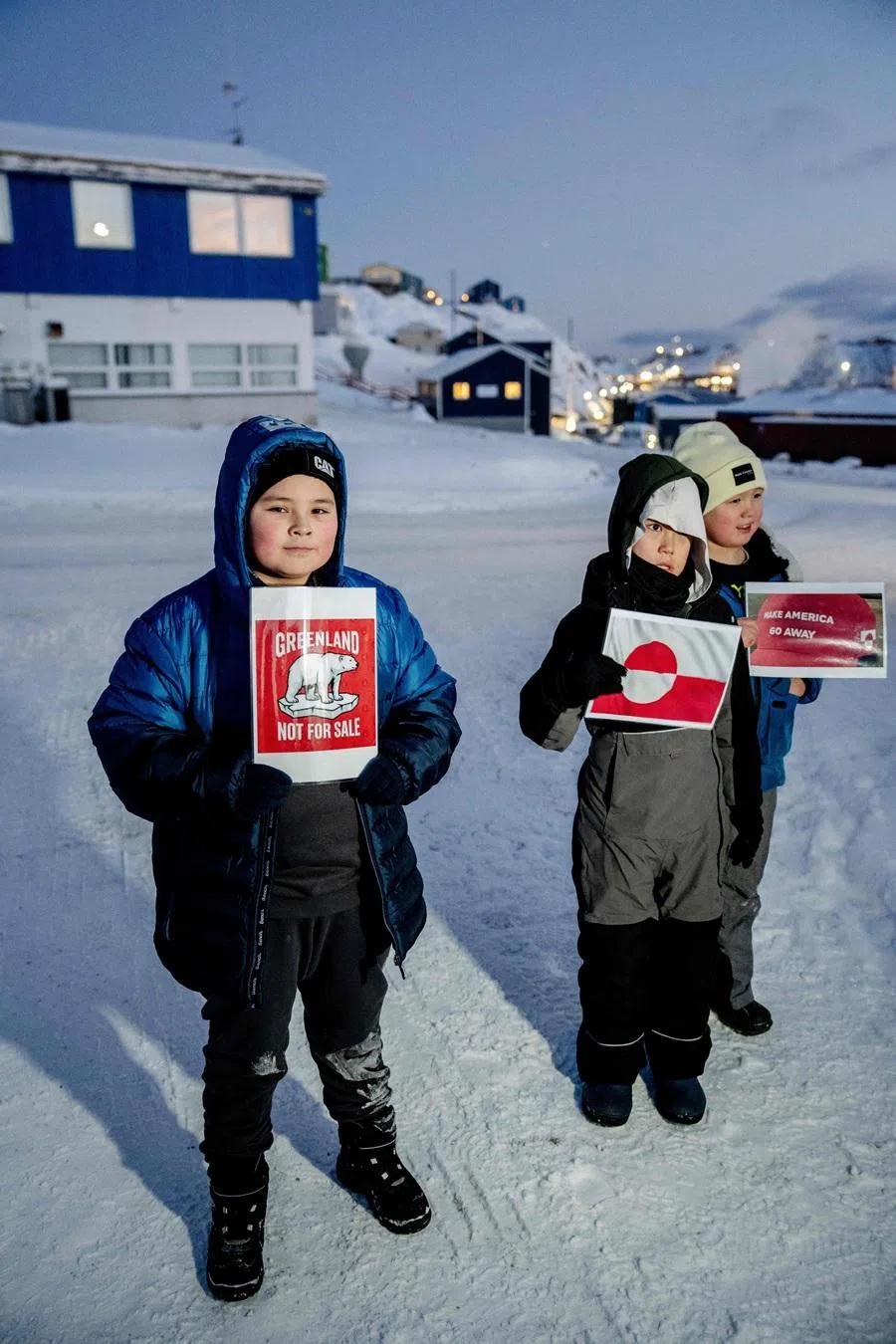A child holds a sign reading "Greenland not for sale" outside the US consulate in Nuuk, Greenland, on 20 January 2026. (Mads Claus Rasmussen/Ritzau Scanpix via AFP)