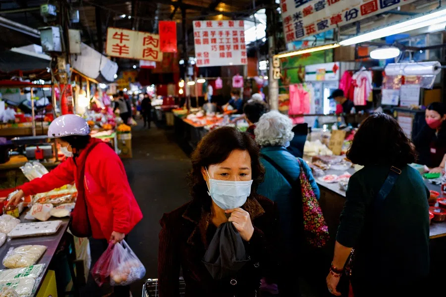 People buy food items at a market in New Taipei City, Taiwan, on 31 January 2024. (Ann Wang/Reuters)