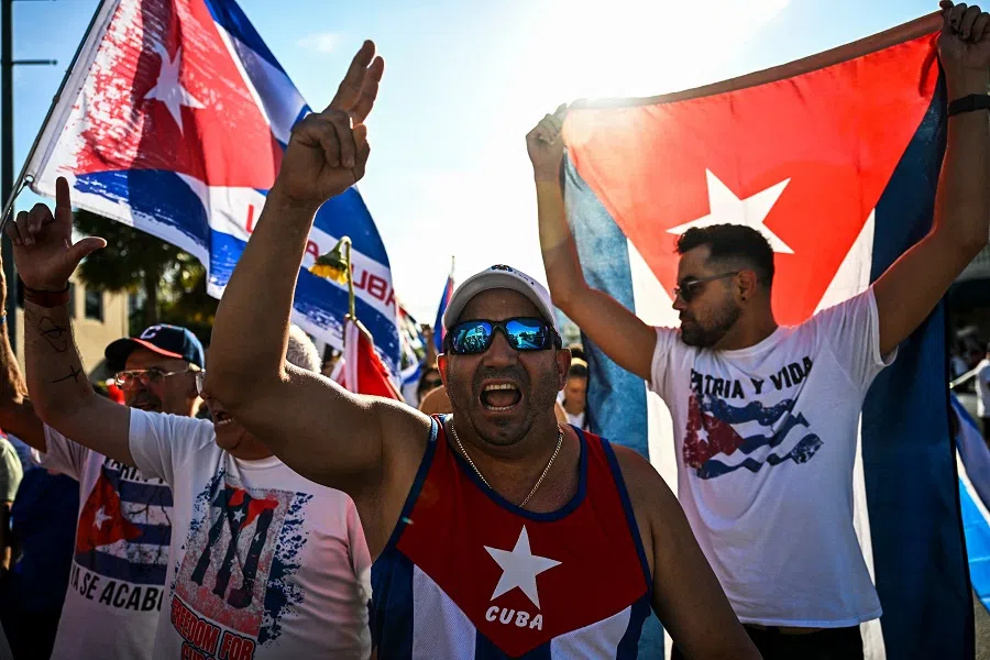 People shout slogans as they march through the streets of Miami, Florida, to commemorate last year's historic protests in Cuba, on 11 July 2022. (Chandan Khanna/AFP)