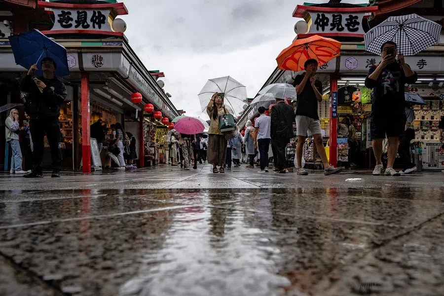 People use their umbrellas to shelter from the rain as they visit the Sensoji Temple in Tokyo, Japan, on 2 June 2023. (Philip Fong/AFP)