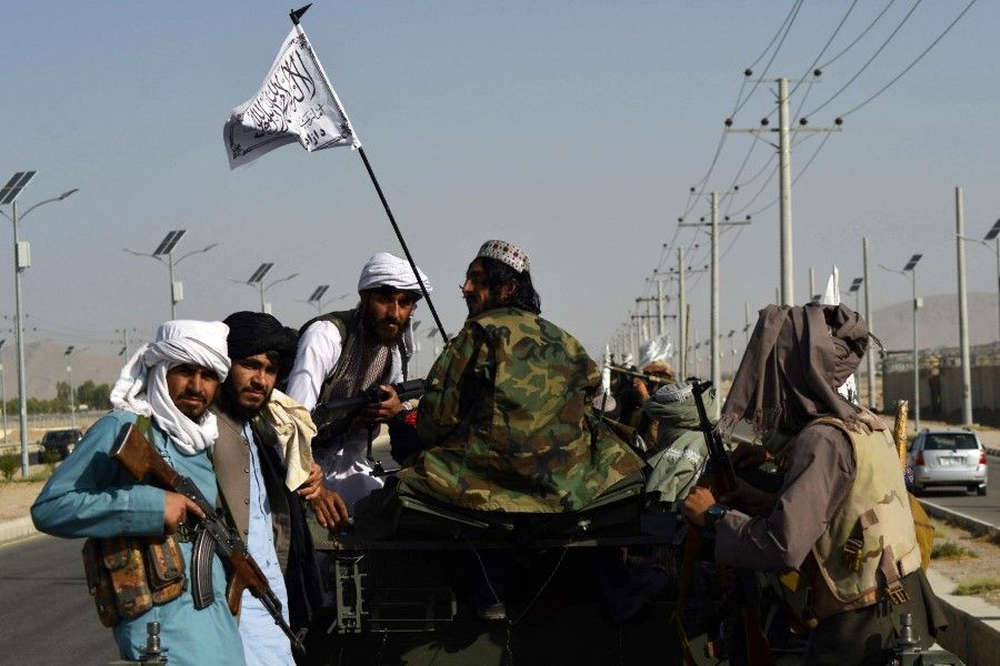 Taliban fighters stand on an armoured vehicle after the US pulled all its troops out of Afghanistan, in Kandahar on 1 September 2021 following the Taliban's military takeover of the country. (Javed Tanveer/AFP)