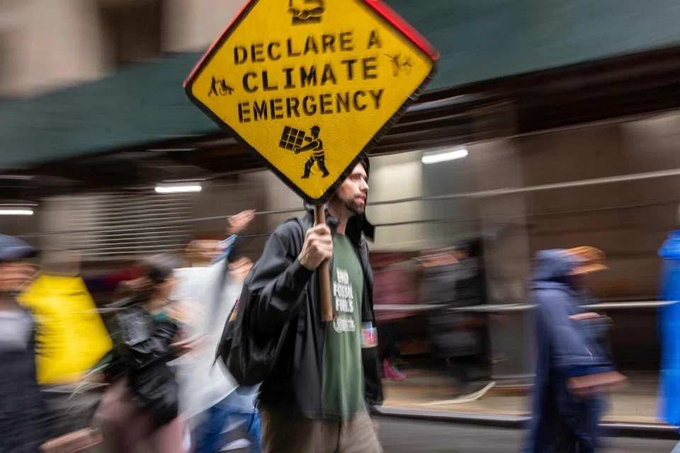 People involved in climate activism hold a demonstration in the Financial District of Manhattan to demand an end to fossil fuel funding by Wall Street and the American government on 18 September 2023 in New York City, US. (Spencer Platt/Getty Images/AFP)
