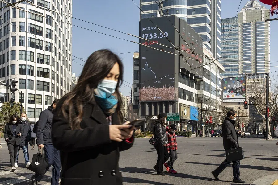 Pedestrains on a street in Shanghai, China, 30 January 2023. (Qilai Shen/Bloomberg)