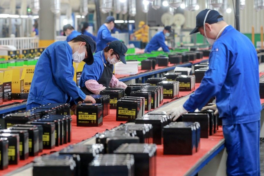 Employees working on a battery production line at a factory in Huaibei in China's eastern Anhui province, 30 March 2020. (STR/AFP)