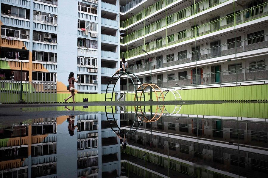 People take photos at a playground in a public housing estate in Hong Kong on 29 August 2021. (Bertha Wang/AFP)