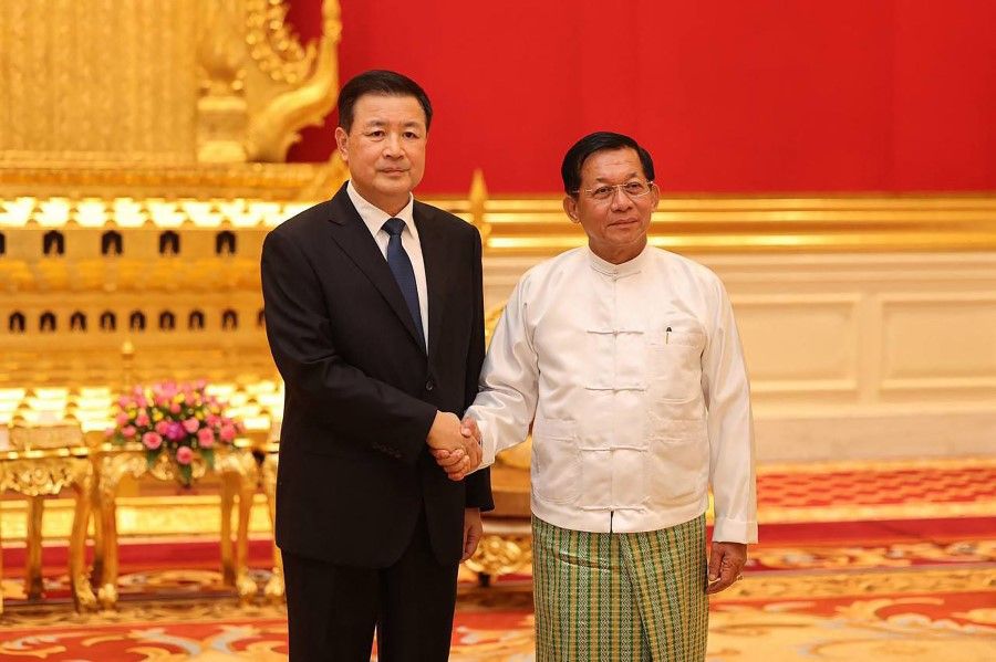 This handout photograph taken on 31 October 2023 and released on 1 November 2023 by the Myanmar Military Information Team shows Myanmar's military chief Min Aung Hlaing (right) shaking hands with China's Minister of Public Security Wang Xiaohong during a meeting in Naypyidaw. (Handout/Myanmar Military Information Team/AFP)