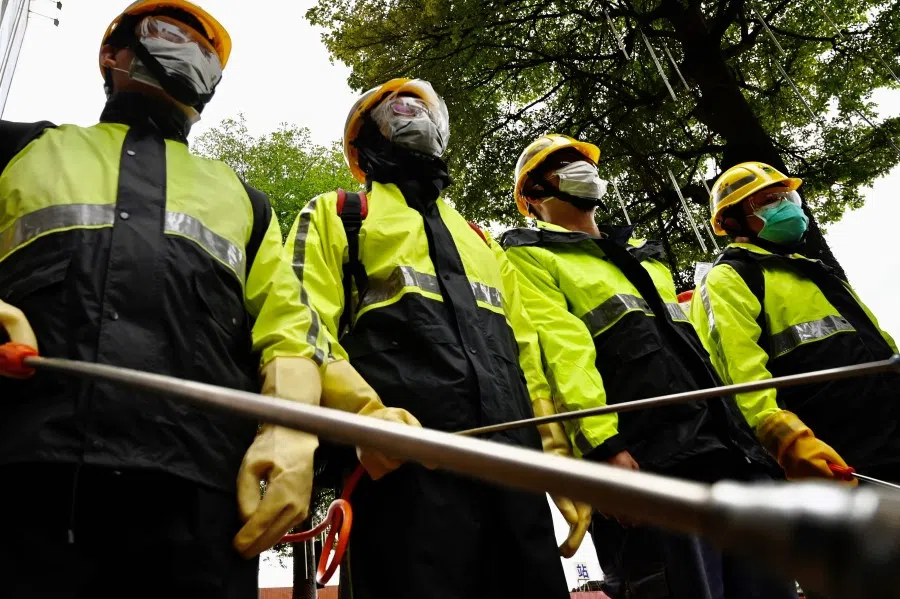 Environmental staff spread disinfectant at a train station in Taoyuan City, April 1, 2020. (Sam Yeh/AFP)