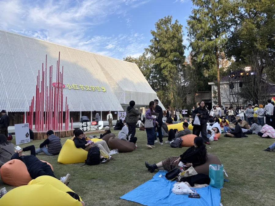 People sit on the ground at the literature festival.