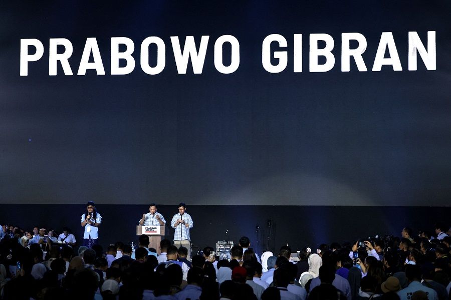 Indonesian presidential candidate Prabowo Subianto (centre) and vice-presidential candidate Gibran Rakabuming Raka (centre, right), Indonesian President Joko Widodo's son and current Surakarta City mayor, pray on the stage during their gathering with supporters after polls closed in the country's presidential and legislative elections in Jakarta on 14 February 2024. (Yasuyoshi Chiba/AFP)