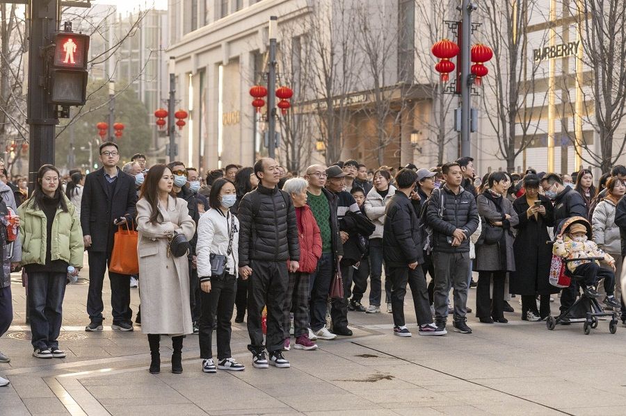 People on a street in Shanghai, China, on 11 February 2024. (Raul Ariano/Bloomberg)