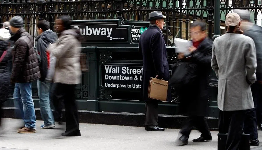 People exit from the subway to Wall Street in New York, 22 January 2008.