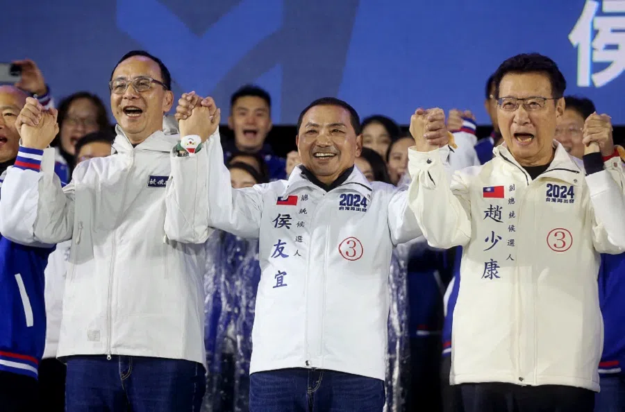 Kuomintang (KMT) Chairman Eric Chu (left), KMT presidential candidate Hou Yu-ih (centre) and running mate Jaw Shaw-kong (right) cheers to supporters during a campaign rally ahead of Taiwan's presidential election, in Taipei, on 23 December 2023. (I-Hwa Cheng/AFP)