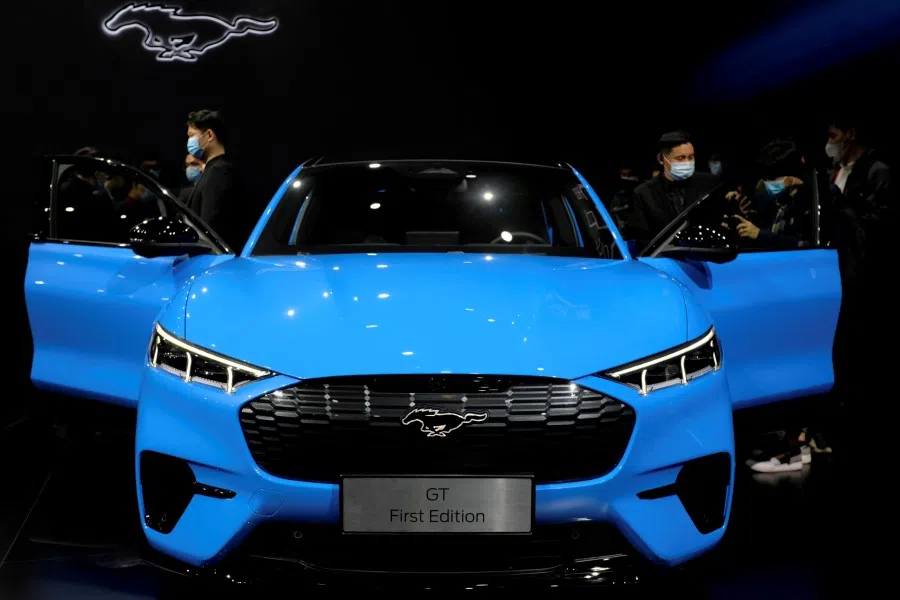 Visitors check on a Ford Mustang Mach-E electric vehicle displayed at a launch event in Shanghai, China, 13 April 2021. (Yilei Sun/Reuters)