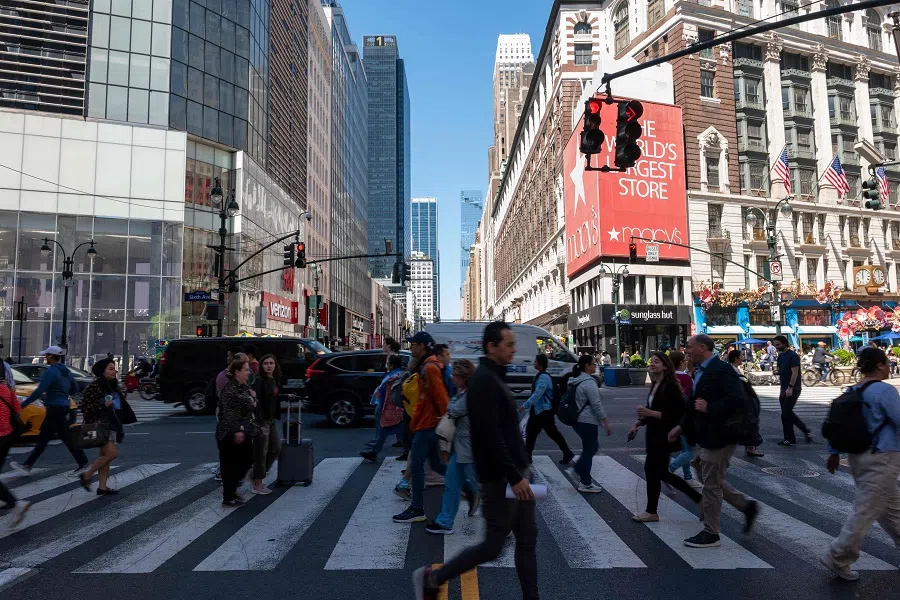 People walk along a street in Manhattan on 30 April 2025 in New York City. Newly released data shows that the US economy just had its worst quarter in three years. (Spencer Platt/AFP)