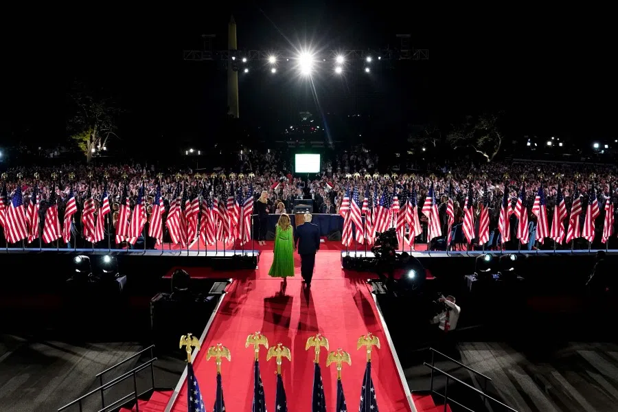 US President Donald Trump (R) arrives with wife First Lady Melania Trump to deliver his acceptance speech for the Republican Party nomination for reelection during the final day of the Republican National Convention from the South Lawn of the White House on 27 August 2020 in Washington, DC. (Doug Mills/AFP)