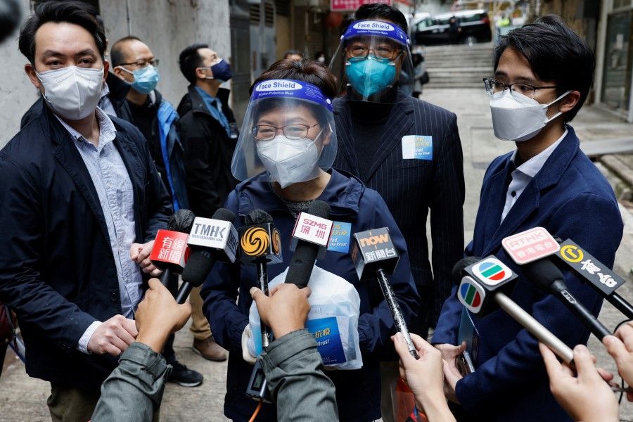 Hong Kong Chief Executive Carrie Lam talks to the media after delivering anti-epidemic service bags to residents during the Covid-19 pandemic, in Hong Kong, China, 2 April 2022. (Tyrone Siu/Reuters)