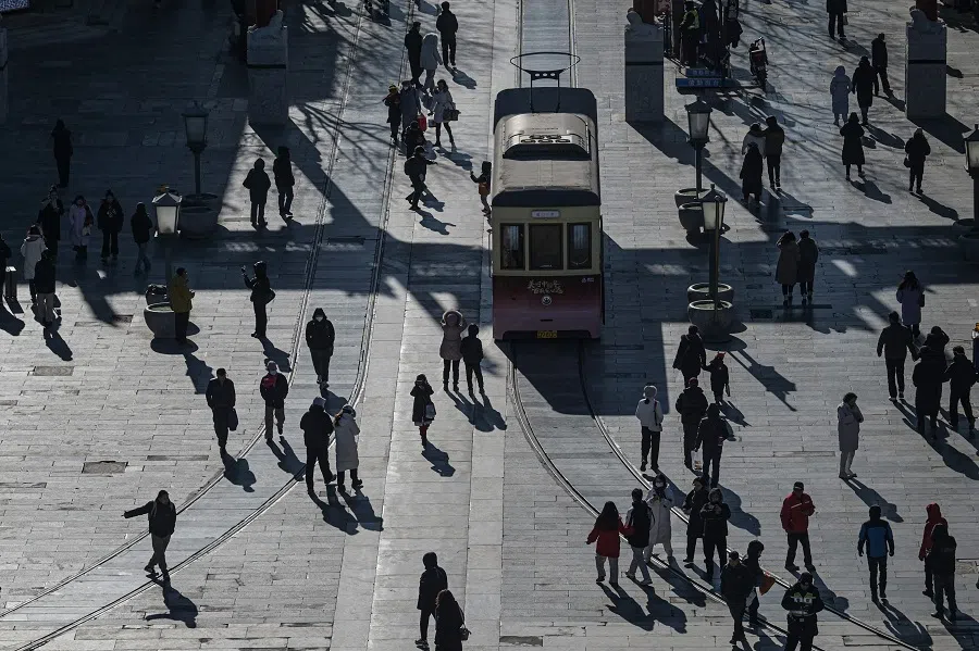 People walk on Qianmen street as seen from Zhengyangmen Gate, the ancient watchtower south of Tiananmen Square, in Beijing, China, on 9 January 2025. (Jade Gao/AFP)