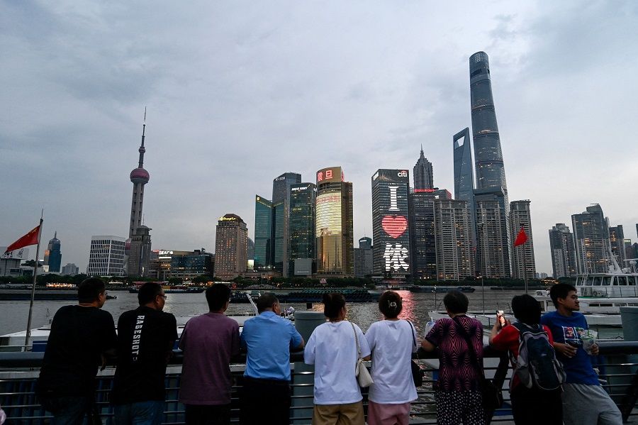 People are seen visiting the Bund promenade along the Huangpu river at the Huangpu district in Shanghai, China, on 29 June 2023. (Pedro Pardo/AFP)