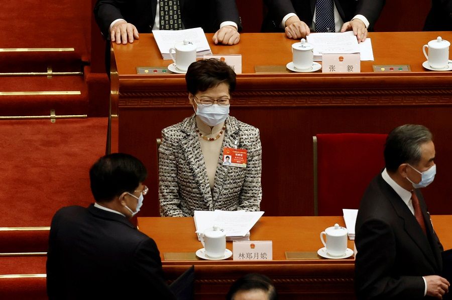 Hong Kong Chief Executive Carrie Lam sits before the opening session of the National People's Congress (NPC) at the Great Hall of the People in Beijing, China, 5 March 2021. (Carlos Garcia Rawlins/Reuters)