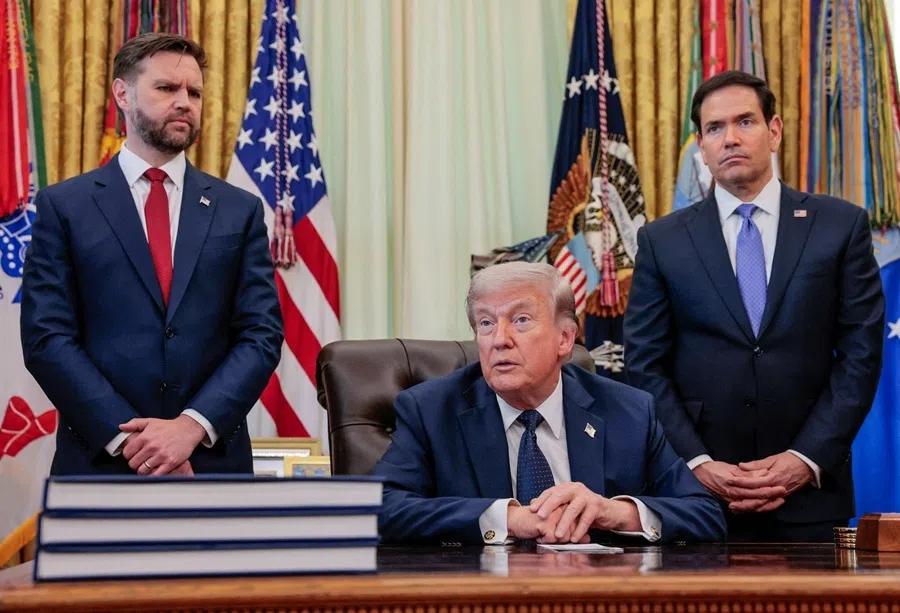 US President Donald Trump speaks in the Oval Office, with Vice-President JD Vance and Secretary of State Marco Rubio standing behind him, at the White House in Washington, DC, US, 23 April 2026.