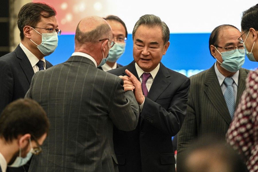 Chinese Foreign Minister Wang Yi (centre) chats with guests after the opening ceremony of the Lanting Forum in Beijing on 25 June 2021. (Jade Gao/AFP)