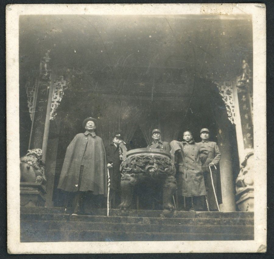 Bai Chongxi (first from left) and Bai Xiandao (second from right) in an ancient temple.