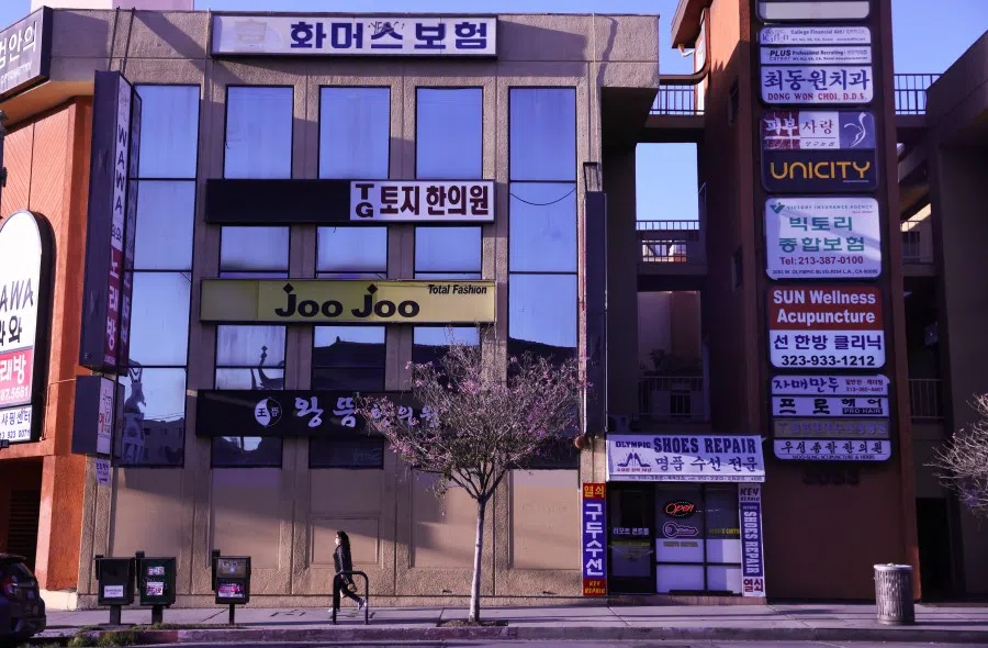 A pedestrian walks in the Koreatown neighborhood on 18 March 2021 in Los Angeles, California. (Mario Tama/Getty Images/AFP)