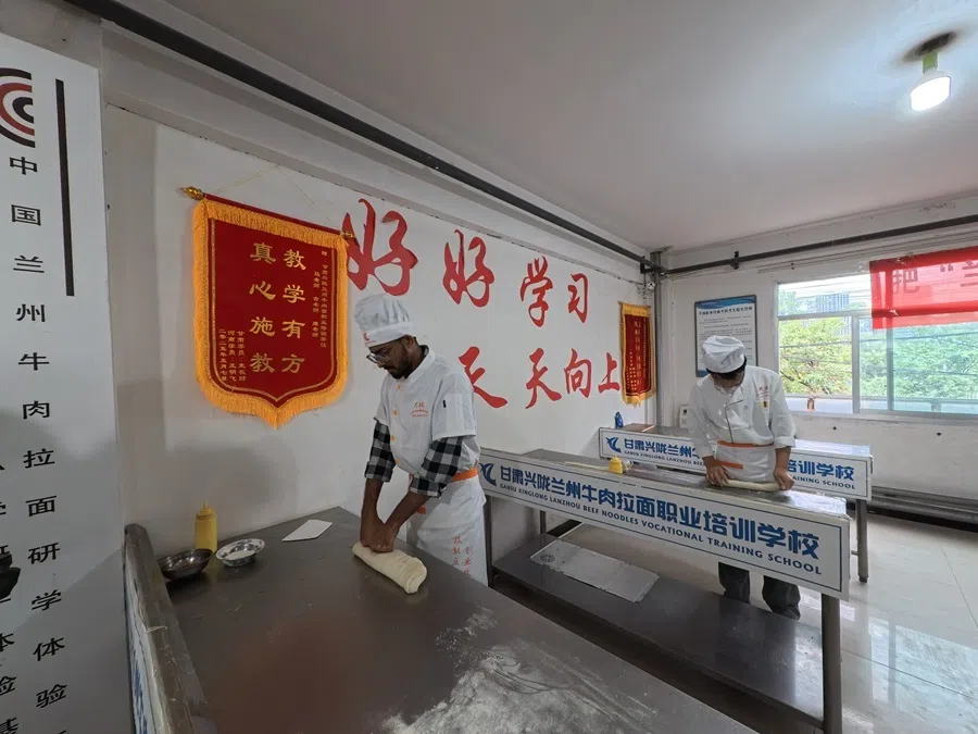 Hand-pulled noodles training at the Gansu Xinglong Lanzhou Beef Noodle Vocational Training School.