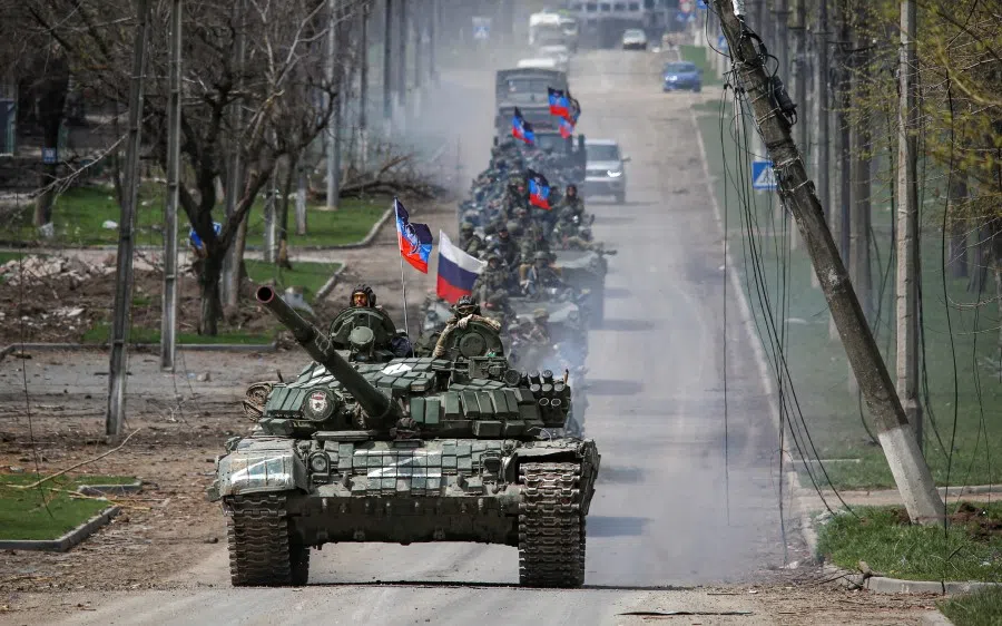 An armoured convoy of pro-Russian troops moves along a road during the Russia-Ukraine conflict in the southern port city of Mariupol, Ukraine, 21 April 2022. (Chingis Kondarov/Reuters)