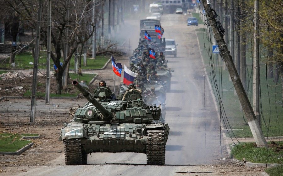 An armoured convoy of pro-Russian troops moves along a road during the Russia-Ukraine conflict in the southern port city of Mariupol, Ukraine, 21 April 2022. (Chingis Kondarov/Reuters)