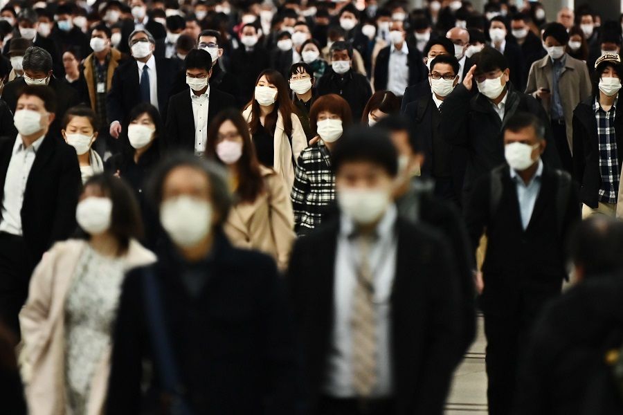 People commute to work at Shinagawa station in Tokyo, Japan, on 16 April 2020. Japan is handing out ¥100,000 to all citizens for virus relief. (Charly Triballeau/AFP)