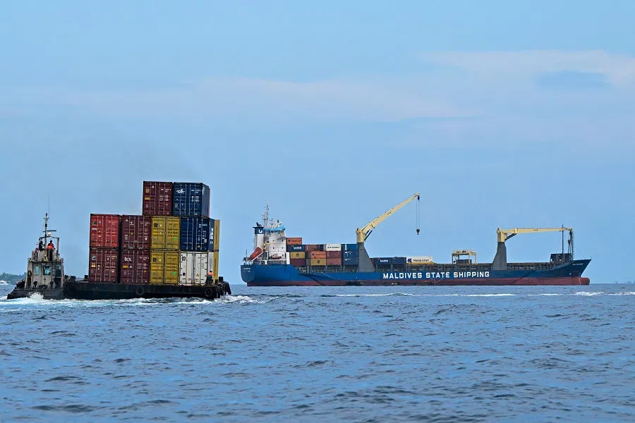 A container ship (right) is pictured from the jetty on the island of Male, the Maldives, on 14 November 2023. (Ishara S. Kodikara/AFP)