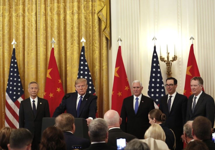 Former US President Donald Trump (second from left) prepares to speak during a signing ceremony for the US-China "phase one" trade agreement in Washington, DC, US, on 15 January 2020. (Zach Gibson/Bloomberg)