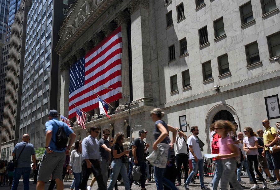 People walk past the New York Stock Exchange in New York, US, on 27 May 2022. (Angela Weiss/AFP)