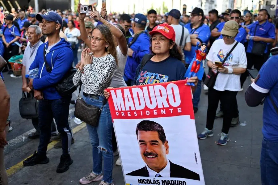 A demonstrator displays a sign with an image of US-deposed Venezuelan President Nicolas Maduro during a march outside the National Assembly on the day Vice President Delcy Rodriguez was formally sworn in as Venezuela’s interim president, as Maduro appeared in a New York court after the Trump administration removed him from power, in Caracas, Venezuela, on 5 January 2026. (Maxwell Briceno/Reuters)