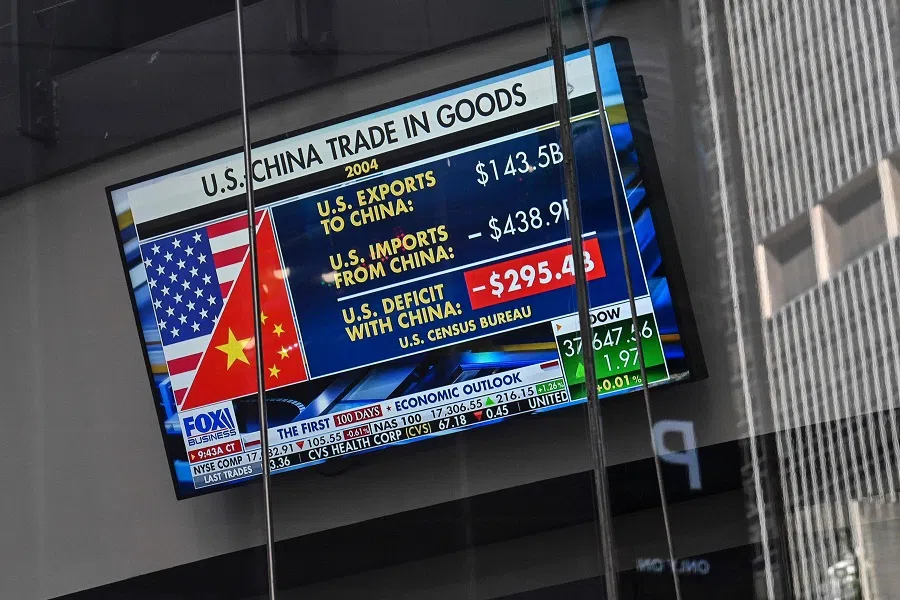 A television screen displays news about trade between the United States and China, at the Nasdaq MarketSite in Times Square, New York City, US on 9 April 2025. (Angela Weiss/AFP)