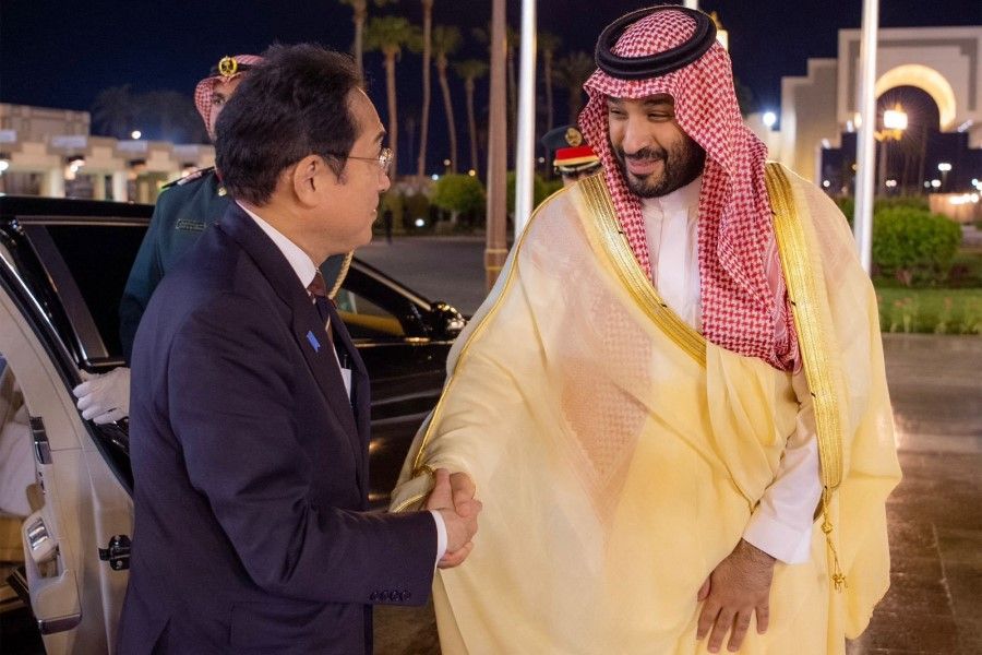 This handout picture provided by the Saudi Press Agency SPA on 16 July 2023 shows Saudi Crown Prince Mohammed bin Salman (right) welcoming Japanese Prime Minister Fumio Kishida in Jeddah. (Bandar Al-Jaloud/SPA/AFP)