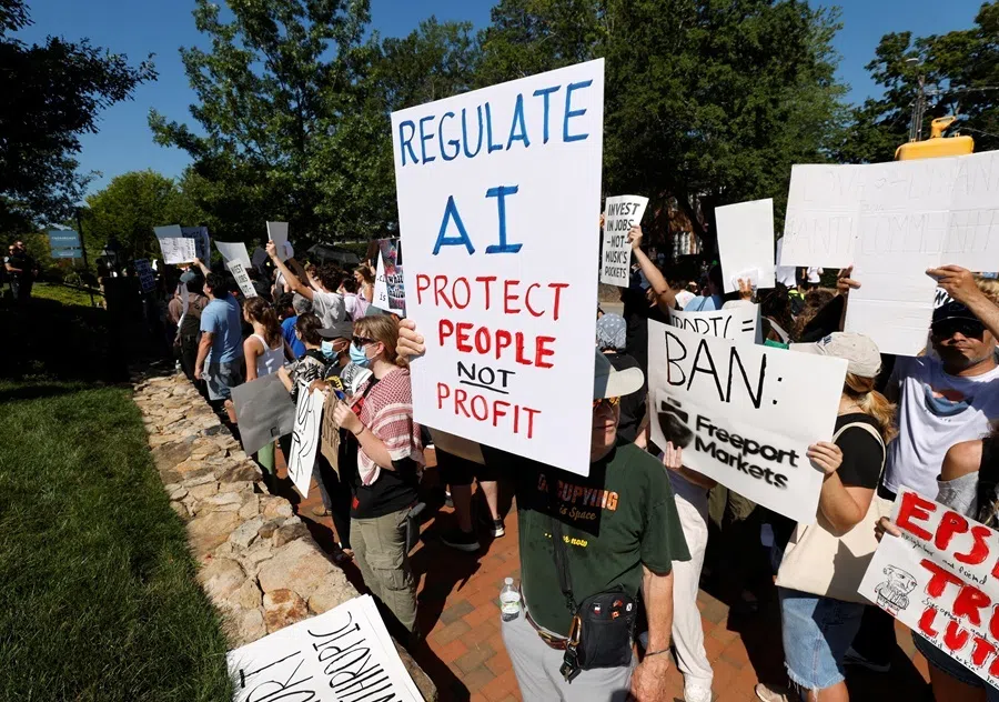 A demonstrator holds a sign calling for regulation of artificial intelligence during a protest outside the G20 Innovation Ministerial summit, in Chapel Hill, North Carolina, US, on 2 September 2026.