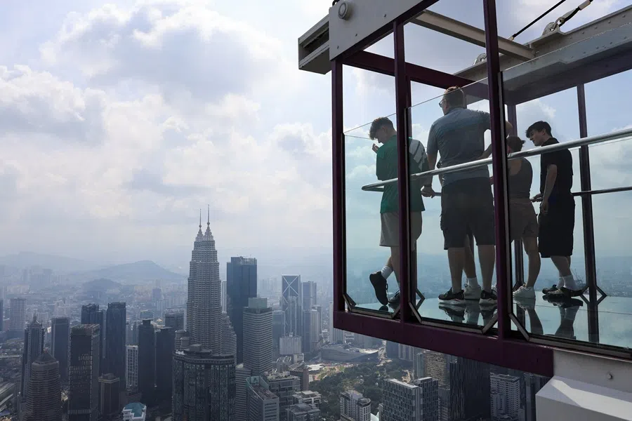 People look at Kuala Lumpur's skyline from an observation deck, in Kuala Lumpur, Malaysia, 31 July 2025. (Hasnoor Hussain/Reuters)