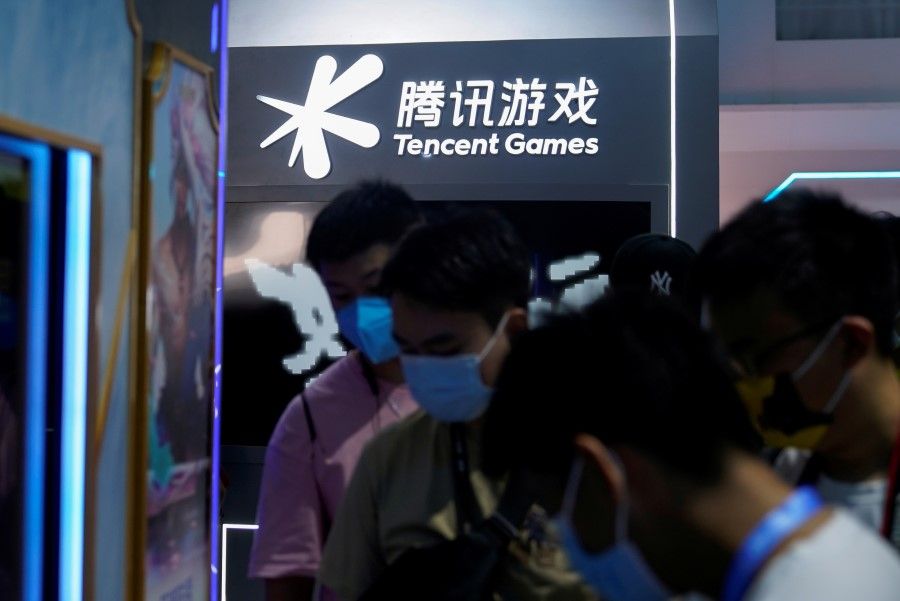 Visitors are seen at the Tencent Games booth during the China Digital Entertainment Expo and Conference, also known as ChinaJoy, in Shanghai, China, 30 July 2021. (Aly Song/Reuters)