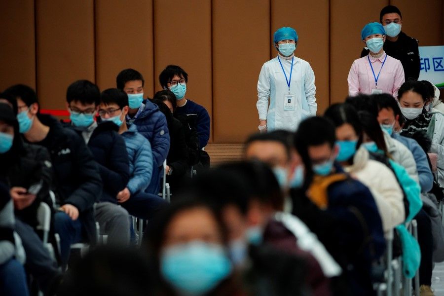 People sit at a vaccination site after receiving a dose of a coronavirus disease (COVID-19) vaccine, during a government-organised visit, following the coronavirus disease (COVID-19) outbreak, in Shanghai, China, 19 January 2021. (Aly Song/Reuters)