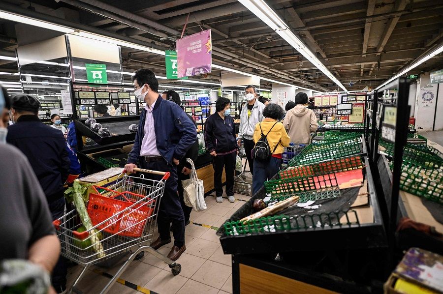 People buy food and household items at a supermarket in Beijing, China, on 12 May 2022. (Jade Gao/AFP)