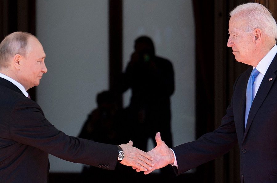 In this file photo, Russian President Vladimir Putin (left) shakes hands with US President Joe Biden prior to the US-Russia summit at the Villa La Grange, in Geneva, Switzerland, on 16 June 2021. (Brendan Smialowski/AFP)