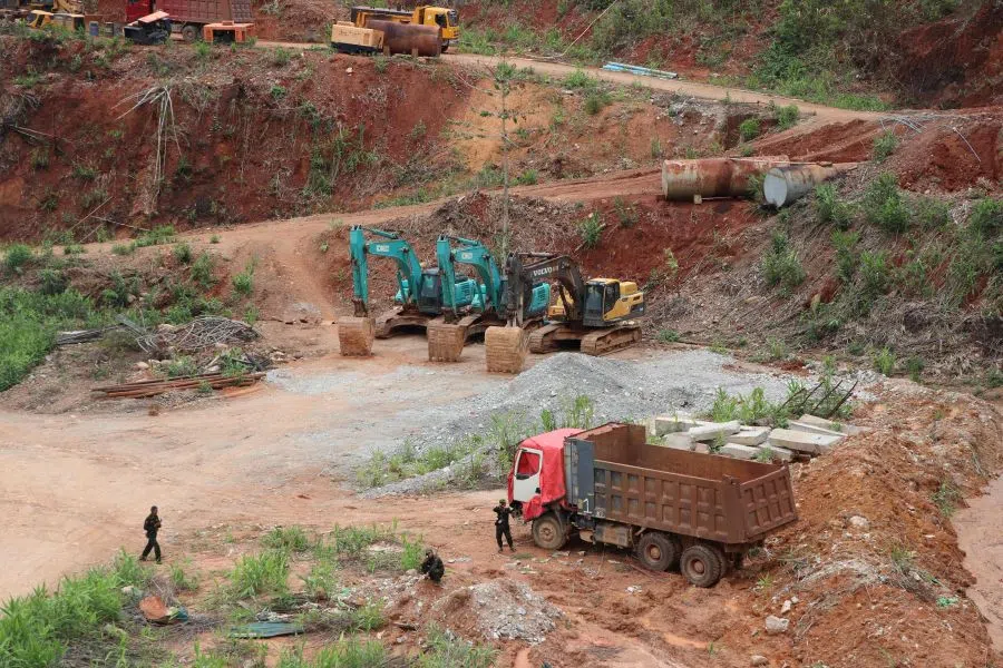 This photo taken on 2 May 2025 shows members of the Kayan New Land Party standing guard at a China-backed battery metal mine in Pekon township in Myanmar‘s eastern Shan State. (AFP)