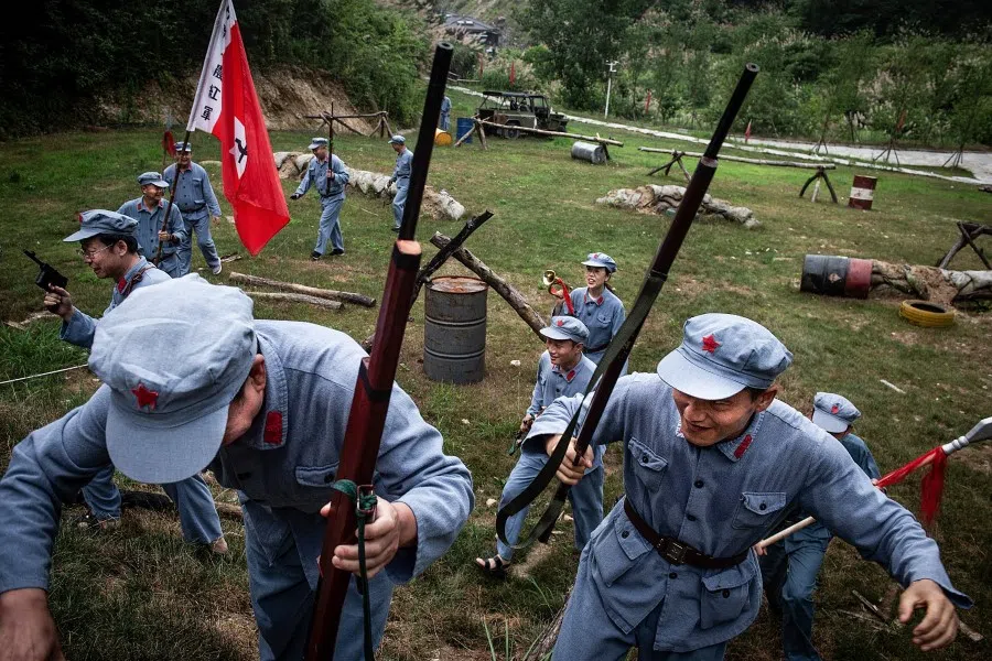 This photo taken on 26 June 2021 shows tourists wearing Red Army uniforms at Yingshan Long March Spirit Experience Park in Huanggang, in China's central Hubei province. (STR/AFP)