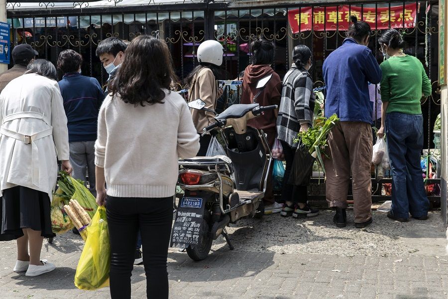 Residents purchase vegetables outside of the impacted areas during a lockdown due to Covid-19 in Shanghai, China, on 30 March 2022. (Qilai Shen/Bloomberg)