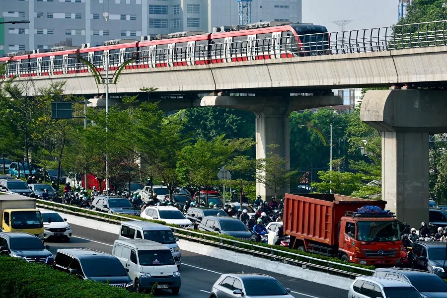 A light rapid transit (LRT) and motorists commute during the morning rush hour in Jakarta, Indonesia on 4 June 2024. (Bay Ismoyo/AFP)